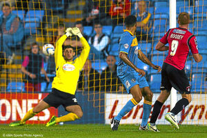 Game over Oldham striker Adam Rooney fires past Shrewsbury keeper Joe Anyon to put the Latics 3-0 up and on their way through to round two of the Johnstones Paint Trophy.