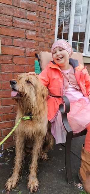 Amelia with a friend's dog, Pilot, ringing the bell at home in Montgomery