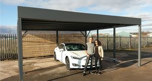 Parveen Begum with business partner Mark Maurice, and one of their solar-powered car ports