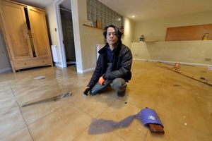 Mark Davies from Darwin's Townhouse in some of the remaining floodwater at the bed and breakfast