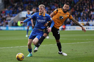 Taylor Perry of Shrewsbury Town and Jordan Cousins of Cambridge United (AMA)