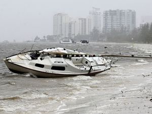 A yacht sits washed ashore in the Broadwater at Labrador