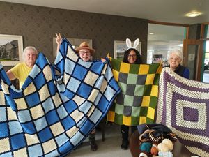 Members of Lawley Bank Court's knit and natter group with their creations