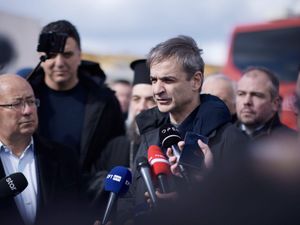 Greek Prime Minister Kyriakos Mitsotakis, right, speaks to the press next to Santorini Mayor Nikos Zorzos