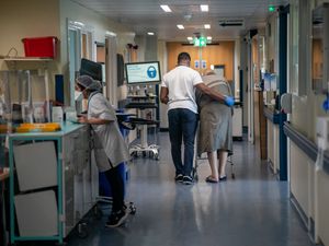 Two people in a hospital ward