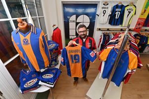 Shrewsbury and Collectable Football shirt shop The 12th Man. A special sale will be coming up raising money for charity, selling off shirts from the collection of the late sports Photographer: Matt Ashton. Owner of the shop: Shaun Owen is pictured with a signed shirt from Dave Edwards's last game, and on the left is one of Shaun's favourite shirts, an early 80s shirt in amazing condition.