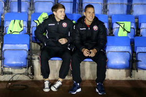 Former Shrewsbury player Tom Bradshaw of Walsall (L) sits on the bench at his former club earlier this season.