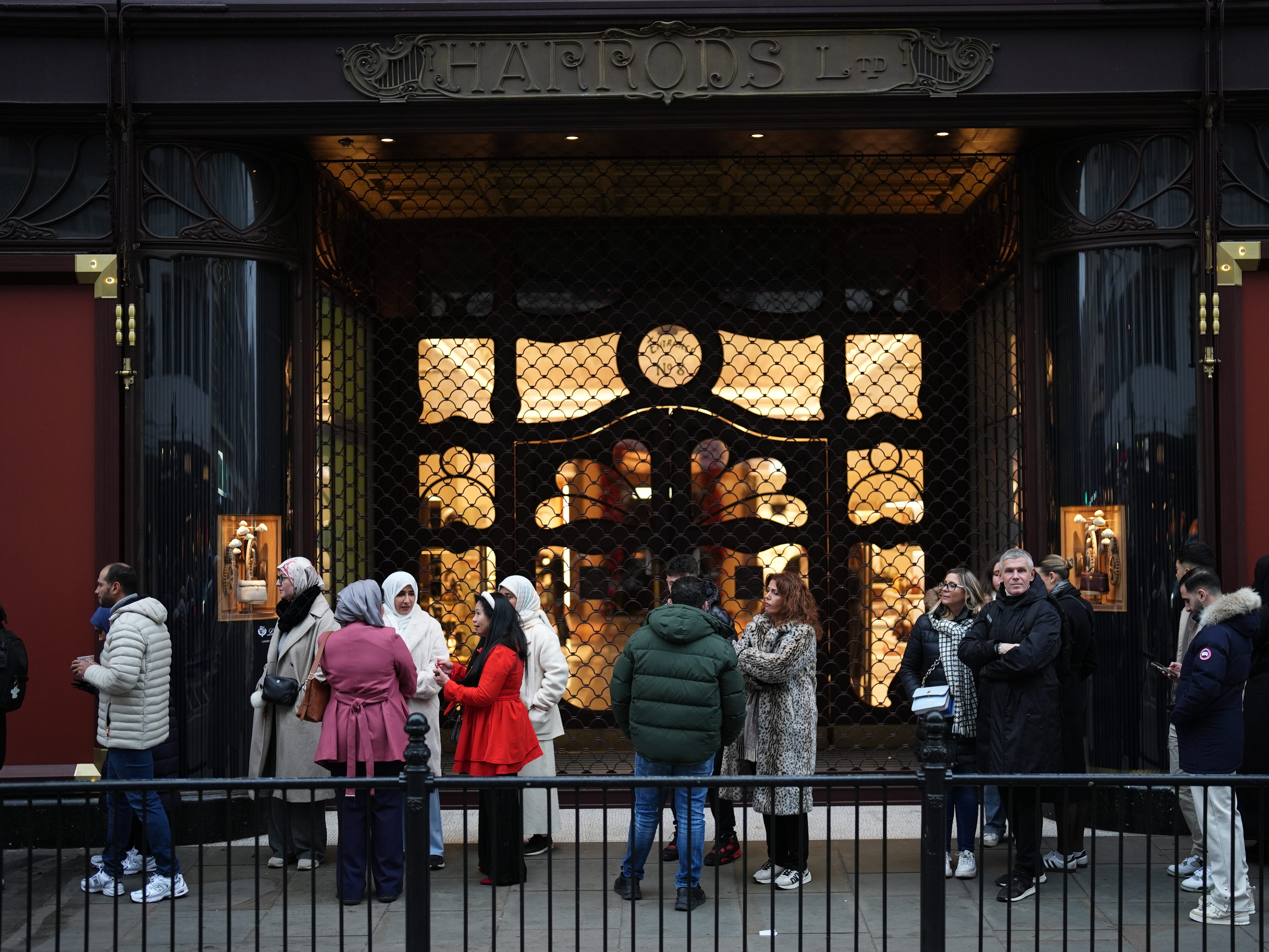 People queue outside the Harrods store in Knightsbridge, London