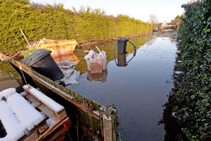 Pumps work to remove the remaining water at the back of the property