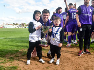 Matty Stenson with his sons after AFC Telford United players and staff lift the Southern Central Premier play-off trophy in front of fans after beating Kettering Town 4-2 at Latimer Park (Picture: Kieren Griffin Photography)