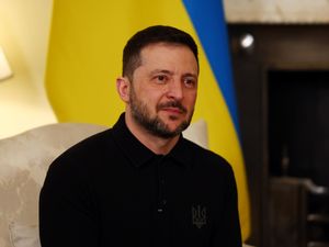 Volodymyr Zelensky looks at the camera