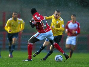 Bruno Fernandes of Workington and Tony Gray of AFC Telford United