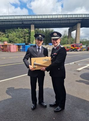 The silver axe award was presented to Llion Jones by Chief Fire Officer Thomas
