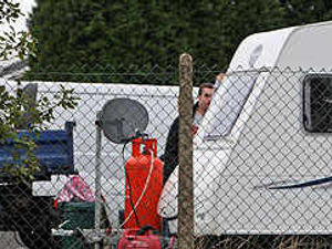 Supporting image for story: Travellers set up camp in car park
