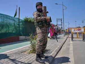 An Indian paramilitary soldier stands guard at a temporary checkpoint in Srinagar, Indian-controlled Kashmir
