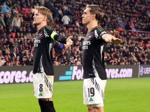 Arsenal's Martin Odegaard, left, celebrates his first goal against PSV Eindhoven with fellow scorer Leandro Trossard