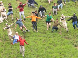 Supporting image for story: Watch the drama as dozens of daredevils join the 2025 Cheese Rolling chase near Gloucestershire