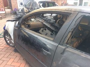 A closer view of the car that was torched