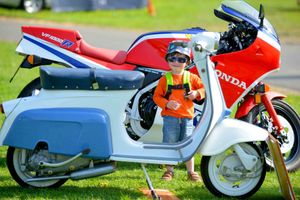 Lucas Deighton, 3, from Northampton looking at a Lambretta