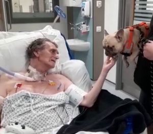 Vic Sharrard being visited by his beloved dog, Ralph