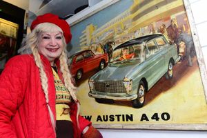 Stella Mitchell with a poster of an Austin A40