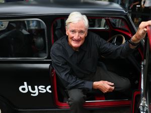 Sir James Dyson climbing out of a vintage Mini