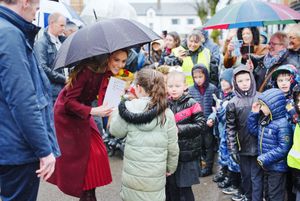 The Princess of Wales shelters from rain under a umbrella whilst meeting members of the public during a visit to the Hanging Gardens. Photo: Ben Birchall/PA Wire