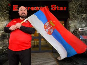 Supporting image for story: Divided loyalties as our reporter flies World Cup flag