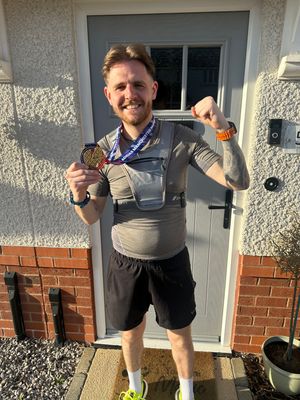 Lewis with his medal after the Manchester Marathon
