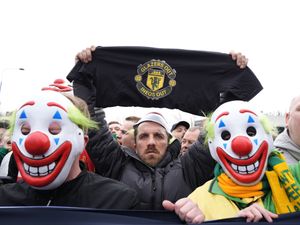 Supporting image for story: Man Utd supporters wear clown masks in protest ahead of Fulham match