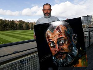 Supporting image for story: Nuno signs portrait ahead of Feed Our Pack charity raffle