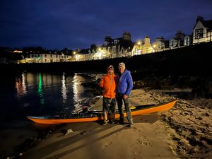 Adam with his dad, who pushed him out to sea for his solo trip