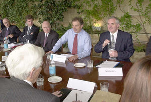 British Prime Minister Tony Blair (centre) after taking his seat between his Irish counterpart Bertie Ahern (right) and Northern Ireland Secretary John Reid at a table with other Ulster politicians at Weston Park