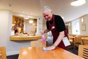 Volunteer Dave Hewitt cleaning tables