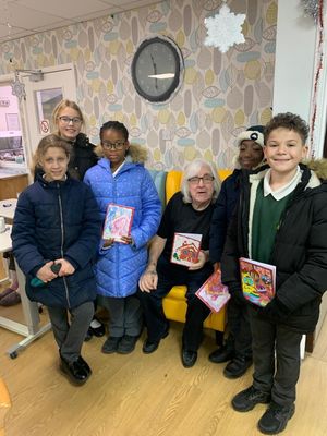 Pupils from Emmanuel School deliver a Christmas card to Stanbrook Care Home resident