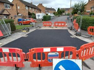 Supporting image for story: Huge sinkhole in middle of road is finally repaired two months after it appeared