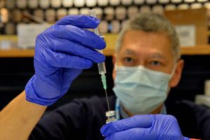 Pharmacist Calvin Cheung mixing the vaccine