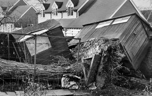 Storm damage in Shrewsbury in February 1990. The caption reads: 'One Shrewsbury garden looked as though it had been struck by an earthquake. Two garden sheds at the home of Mrs Pat Milsom, of Stonehurst Drive, were upended when a 90 foot Scots Pine was uprooted.' It was carried with a number of stories about storms lashing the British Isles
