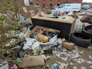 The dog was found taped in bin bags and dumped amongst rubbish