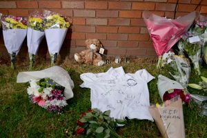 Tributes, including a signed Castlecroft Primary School shirt, at the scene of the stabbing