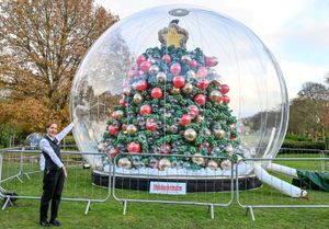 An image shows Elouise Lane, Restaurant Supervisor, with the UK's First Balloon Christmas Tree on display at Moor Hall Hotel and Spa in Sutton Coldfield, West Midlands.