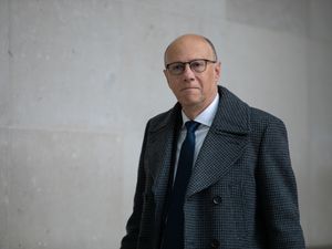 Professor Sir Stephen Powis, wearing shirt tie and coat