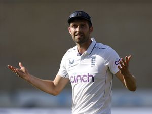 Mark Wood holds his arms up