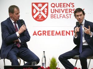 Alastair Campbell (left) and Rory Stewart speaking in front of a Queens University Belfast backdrop