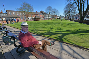 Green keeper Bill Evans oversees his work on a sunny afternoon