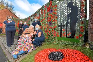 Marjorie Webb with staff and the display at Parklands Court