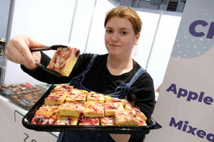  Zoe Allen from Brecon on her Zoe Bakes stand at the Food Hall with her cherry bakewell blondie. Zoe has created her sweet treats at her home for the last five years and it was her first attendance at the Winter Fair although she has previously done the Royal Welsh Show. Jammie dodger blondies are one of her biggest sellers although chocolate orange brownies are popular at this time of year. Image by Andy Compton