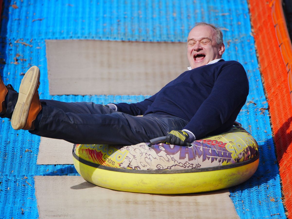 Sir Ed Davey rides rubber ring to highlight pothole problem