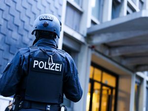 Supporting image for story: Police detain a suspect in the German knife attack that killed three