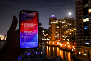 An alert issued by the UAE Ministry of Interior warning residents of Dubai of a potential Iranian missile strike. (Photo by FADEL SENNA / AFP via Getty Images)